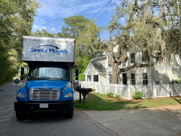 Moving truck from Simple Moving LLC parked outside a house during residential move.