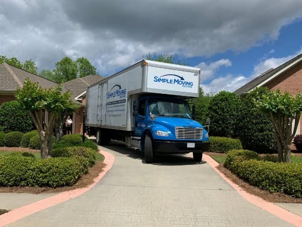 Simple Moving truck delivering in residential neighborhood for local moving services.