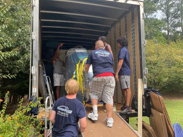 Moving team loading furniture into a truck for a local move.